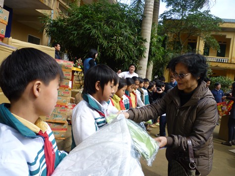 Cô giáo Ngô Anh Thơ, giảng viên ĐHQGHN trao quà cho các em học sinh